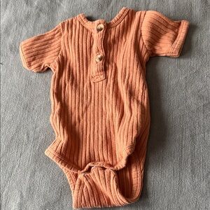 Kate Quinn terracotta ribbed onesie